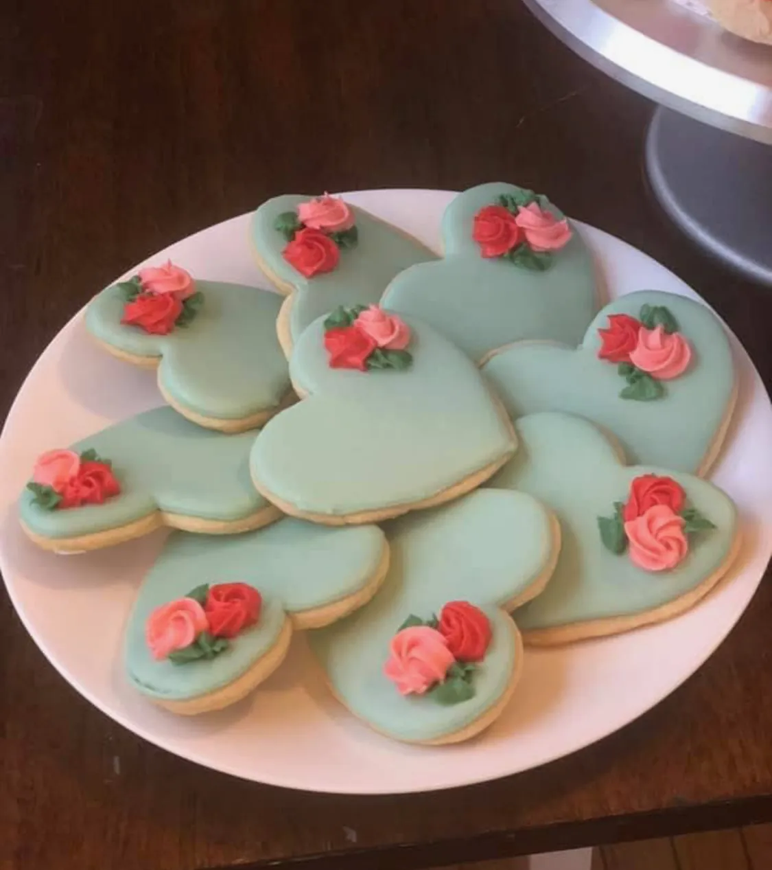 Heart-shaped sugar cookies with sage icing and tiny flower details