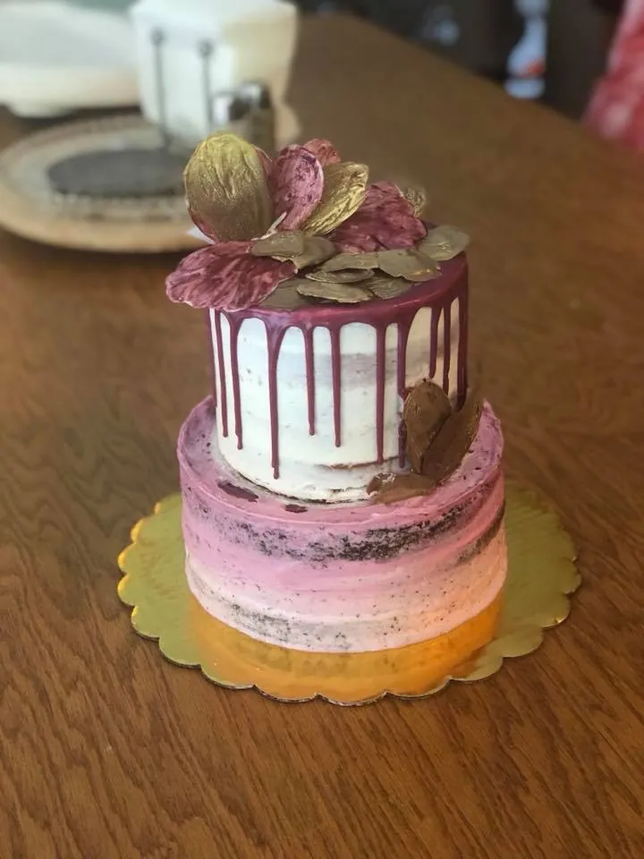 Floral custom cake featuring soft pink and white buttercream details