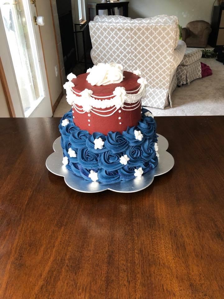 Red, white, and blue celebration cake with piped rosettes