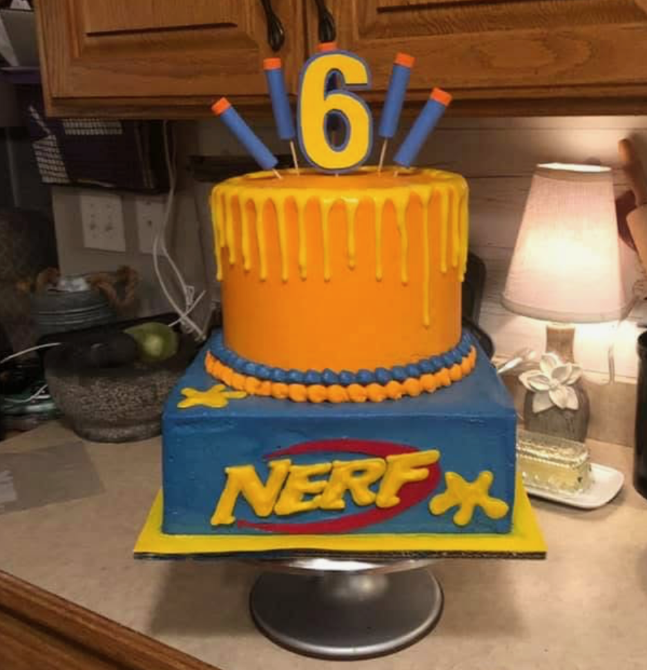 Two-tier orange and blue themed birthday cake