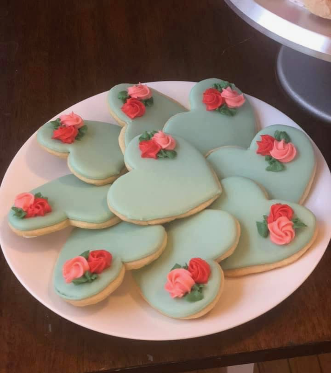 Heart-shaped sugar cookies with sage icing and tiny roses