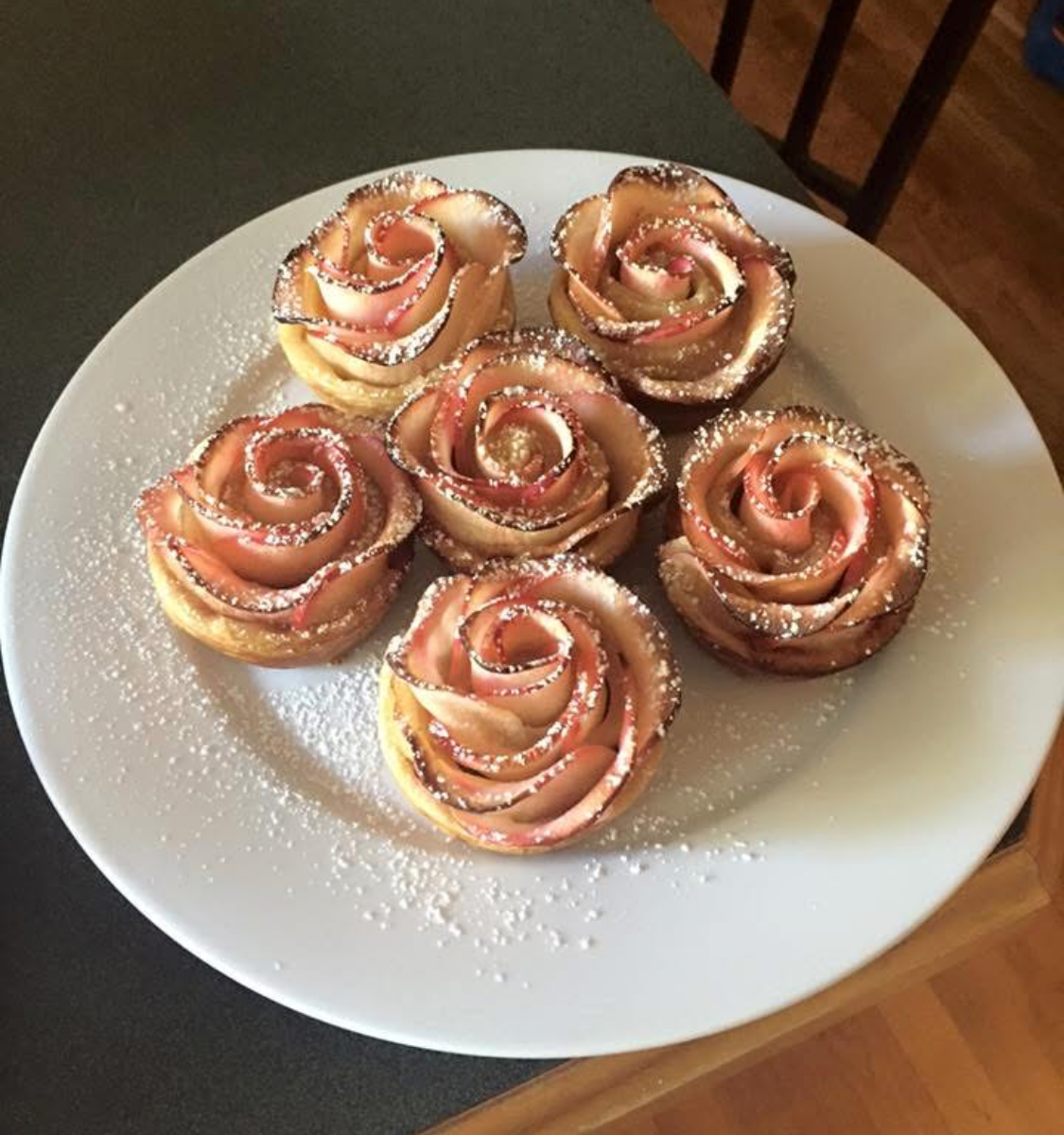 Apple rose pastries dusted with powdered sugar